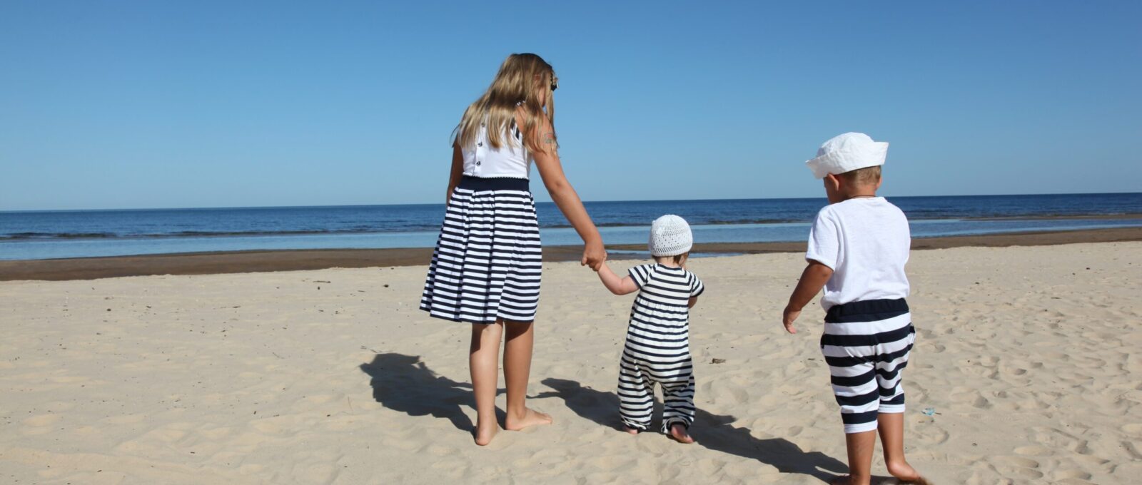 Moeder met kinderen op een Grieks strand